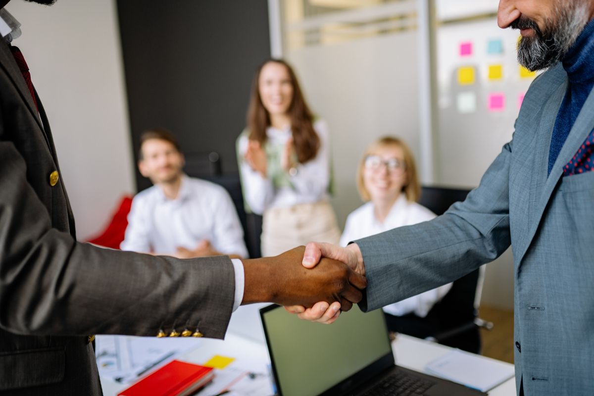 Enterprise stakeholders shaking hands on a multi-system integration engagement
