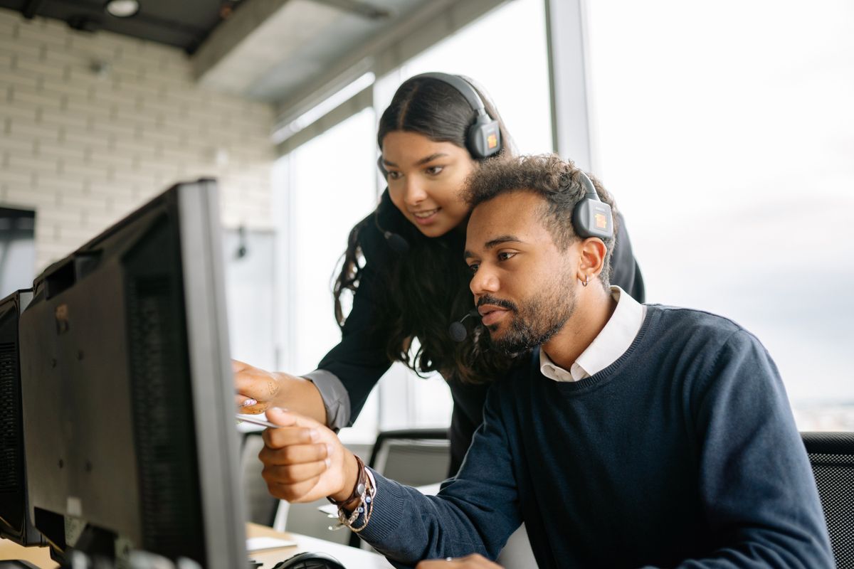 Operations pair monitoring a transfer dashboard together